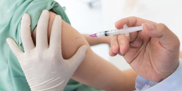 Close up of a Doctor making a vaccination in the shoulder of patient, Flu Vaccination Injection on Arm, coronavirus, covid-19 vaccine disease preparing for human clinical trials vaccination shot.